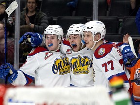 The Edmonton Oil Kings forward Carson Golder (9), Jaxsen Wiebe (43) and Jakub Demek (77) celebrate a goal against the Lethbridge Hurricanes during second period WHL playoff action at Rogers Place in Edmonton, Saturday April 23, 2022.