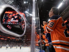 Edmonton Oilers fans cheer for five-year-old Ben Stelter, who has glioblastoma, a type of brain cancer, while the team plays the San Jose Sharks during first period NHL action at Rogers Place on Thursday, April 28, 2022.