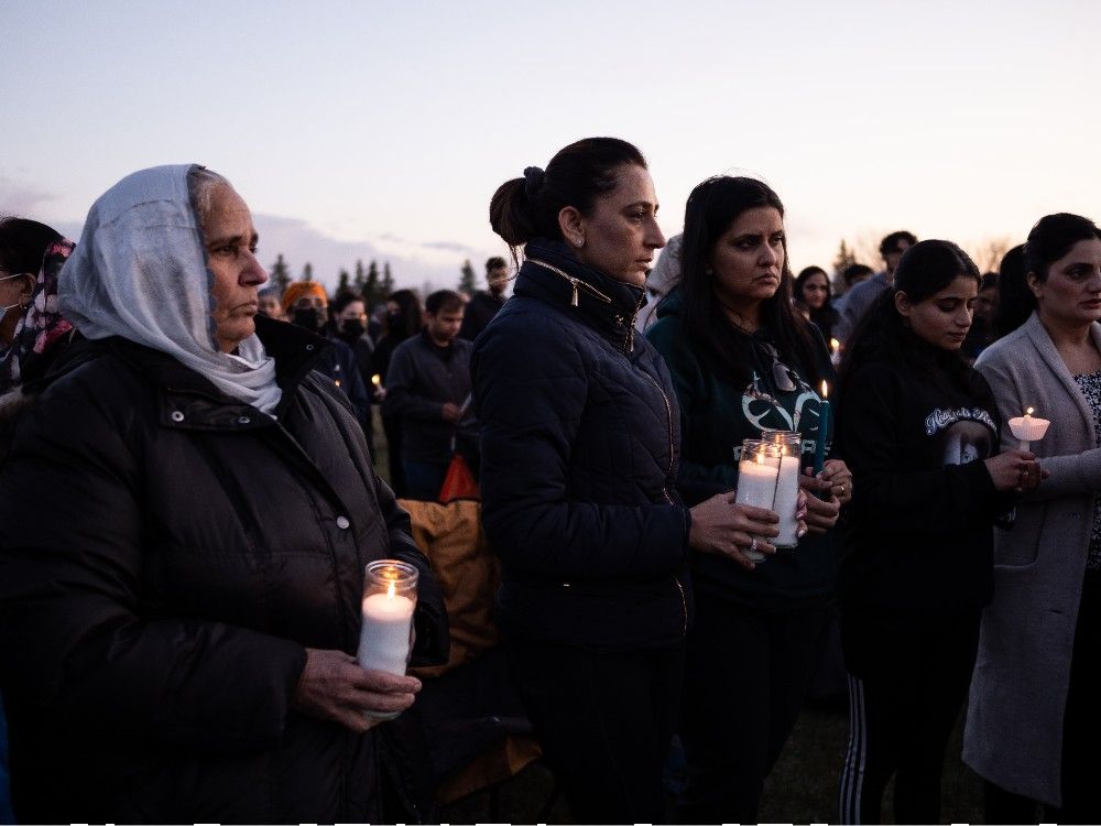 Hundreds gather for candlelight vigil at McNally High School for