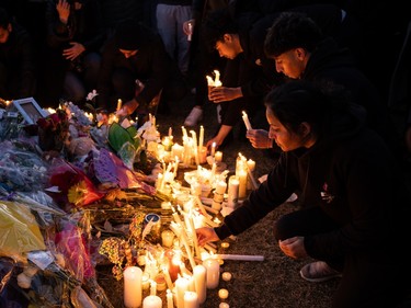 Family and friends lit candles in memory of Karanveer Sahota, who was beaten and stabbed to death outside McNally High School, during a vigil outside his school in Edmonton, on Friday, April 29, 2022.