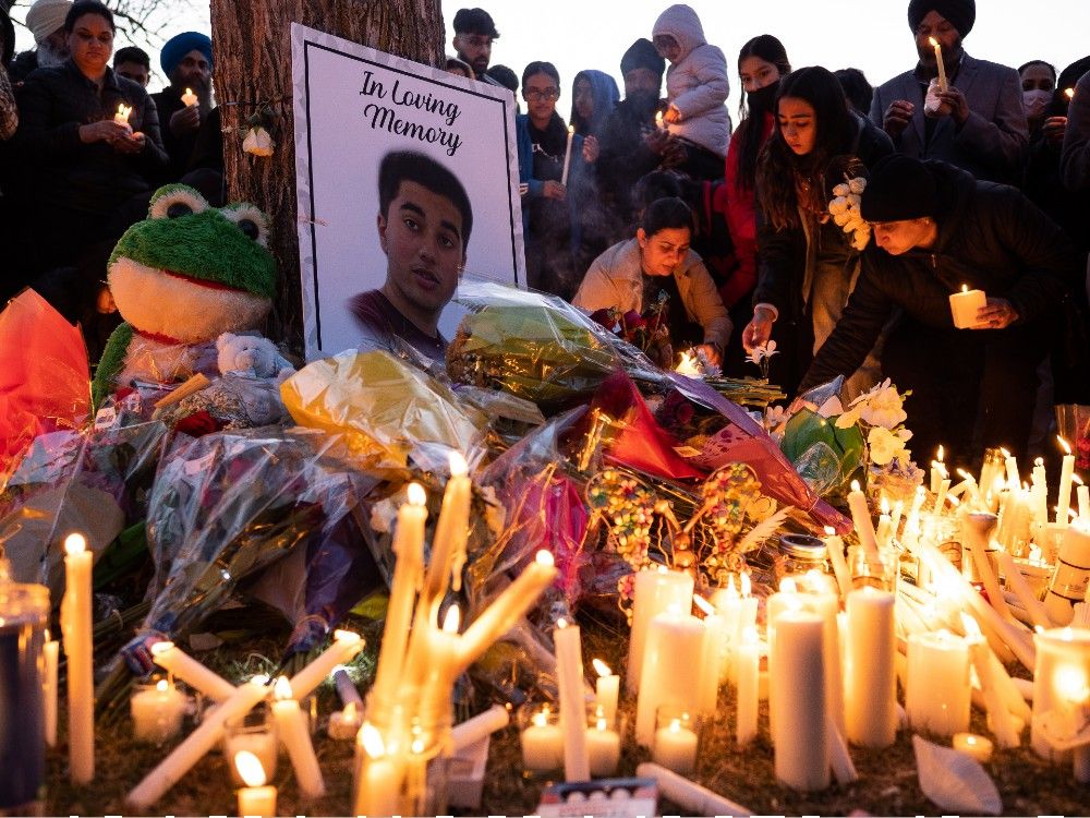 Hundreds gather for candlelight vigil at McNally High School for