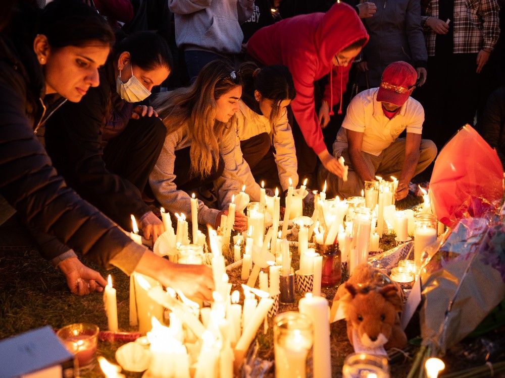 Hundreds gather for candlelight vigil at McNally High School for