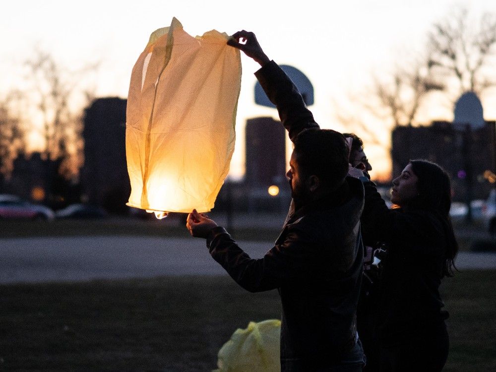 Hundreds gather for candlelight vigil at McNally High School for