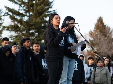 Monica Binns (left) and Shivleen Sidhu speak about their cousin Karanveer Sahota during a vigil in his memory outside McNally High School in Edmonton, on Friday, April 29, 2022.
