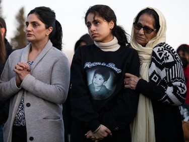 The crowd listens as family and friends speak in memory of Karanveer Sahota, who was beaten and stabbed to death outside McNally High School, during a vigil outside his school in Edmonton, on Friday, April 29, 2022.