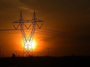 Power lines are seen against a sunset