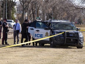 Police investigate the scene outside of McNally High School near the bus stop on Friday, April 8, 2022 in Edmonton.