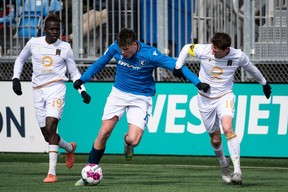 FC Edmonton's Tobias Warschewski (10) battles Valor FC's Daryl Fordyce (16) and William Akio (19) during second half Canadian Premier League soccer action at Clarke Stadium in Edmonton, on Sunday, April 10, 2022.