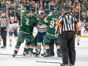 Minnesota Wild defenceman Jonas Brodin (25) and left wing Kirill Kaprizov (97) tangle with Edmonton Oilers left wing Evander Kane (91) at Xcel Energy Center on Tuesday, April 12, 2022.