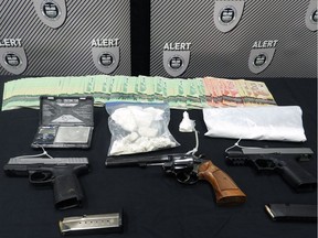 The Alberta Law Enforcement Response Team (ALERT) have charged two Fort McMurray residents after police seized handguns, drugs and cash.