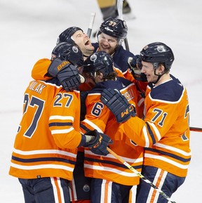 Members of the Edmonton Oilers celebrate a goal scored by Kris Russell (6) against the Vegas Golden Knights during first period NHL action on Saturday, April 16, 2022, in Edmonton.