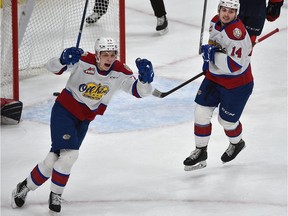Edmonton Oil Kings Jakub Demek (77) and Josh Williams (14) celebrate a goal by Dylan Guenther (11) against the Lethbridge Hurricanes during the WHL first round playoffs at Rogers Place in Edmonton, April 21, 2022.