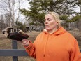 Debbi Wemp holds a burned slipper that belonged to her mother on Monday, April 25, 2022. The slipper was hung to dry on a clothesline about  30 metres from a home which burned to the ground after it was reported at 12:30 a.m. on Sunday April 24, 2022. Debbi's mother, sister-in-law and friend died in the house fire north of Lac Ste. Anne in Darbyson Estates.