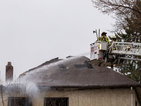 Firefighter work to extinguish a house fire at 9638 108 Ave. on Wednesday, April 27, 2022 in Edmonton.