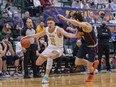 University of Alberta Golden Bears forward Adam Paige (13) goes against Queen's University guard Cole Syllas on the way to a 95-84 Alberta win in the U Sports 2022 men's basketball national bronze-medal game at the Saville Community Sports Centre on Sunday, April 3, 2022.
