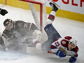 Edmonton Oil Kings forward Jalen Luypen falls over Red Deer Rebels goaltender Connor Ungar in Edmonton on Sunday, April 3, 2022.