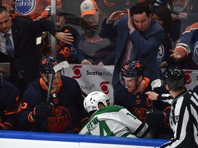 Edmonton Oilers Connor McDavid (97) eyes Dallas Stars Jamie Benn (14) after he was hit and ended up in the Oilers bench during NHL action at Rogers Place in Edmonton, April 20, 2022.