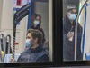 Transit users wear masks in the Peel métro station in Montreal on Tuesday, April 5, 2022.