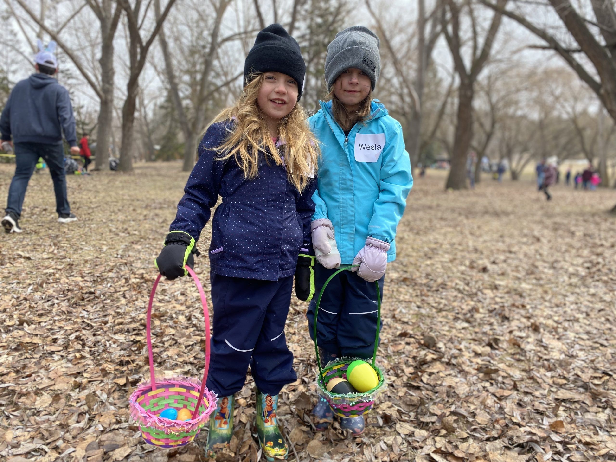 From left, Tarina Harasymchuk 4, and her sister Wesla, 6, participated in a "beeping" Easter egg hunt for children with vision loss in Emily Murphy Park on April 16, 2022.