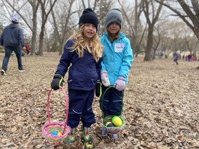 From left, Tarina Harasymchuk, 4, and her sister Wesla, 6, participate in a “beeping” Easter egg hunt for children with vision loss at Emily Murphy Park on April 16, 2022.