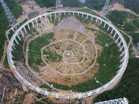 This picture taken on July 29, 2015 shows the five-hundred-metre Aperture Spherical Radio Telescope (FAST) under construction in Pingtang, China. Scientists intend for this telescope and another in northern California to transmit the message.