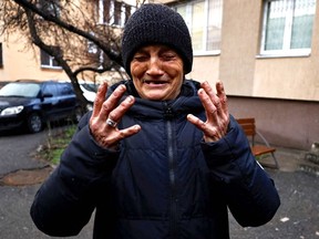 Tanya Nedashkivska, reacts as she mourns her husband Vasyl Ivanovych, who served in the navy, and was killed by Russian soldiers, next to his grave at the garden of their residential building, amid Russia's invasion of Ukraine, in Bucha, Ukraine April 3, 2022.