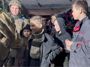 Children celebrate Ukrainian Orthodox Easter with service members in a bunker said by Ukraine's Azov Battalion to be in Azovstal steelworks in Mariupol, on April 23, 2022.