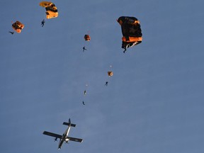 Members of the U.S. Army Golden Knights demonstration parachute team descend into Nationals Park before the game between the Washington Nationals and the Arizona Diamondbacks.