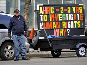 Bill Day protests outside the building housing the Alberta Human Rights Commission office in downtown Edmonton on Thursday April 7, 2022. Day filed a human rights complaint alleging the Assured Income for the Severely Handicapped (AISH) panel's process discriminated against him as a person with hearing loss when the panel refused to give him accommodations so he could understand what was happening during the proceedings. He was representing his wife, who has a cognitive disability.