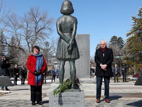 Senator Paula Simons, left, and Honourary Consul of the Netherlands Jerry Bouma pause after laying flowers at the Anne Frank statue and cenotaph in Edmonton's Light Horse Park, 10324 85 Ave., Wednesday, April 20, 2022. Five new educational panels were unveiled in the park.