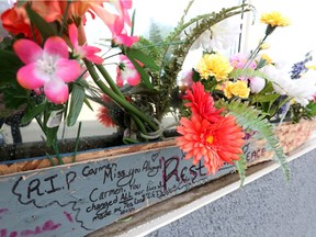 A memorial for Abdullah Shah, also known as Carmen Pervez, is visible outside a building at 9331 111 St., in Edmonton, March 30, 2022. Shah was killed in a March 13, 2022 shooting.