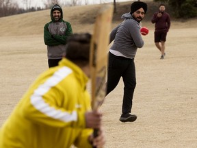 A group of friends play a pick-up game of cricket at A. Blair McPherson School, 430 Tamarack Green NW, in Edmonton, Friday April 15, 2022.