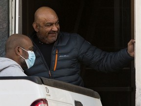 Abdullah Shah (right), also known as Carmen Pervez, is seen at 9331 111 Ave. in Edmonton Thursday Oct. 21, 2021, as police investigated an apparent shooting at a nearby business.