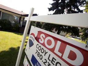 A real estate sold sign is visible outside a single family home in Edmonton on Aug. 12, 2020.