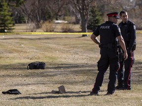 Police investigate the scene outside of McNally High School near the bus stop on Friday, April 8, 2022 in Edmonton.  A witness saw a young man being taken away on a stretcher while receiving chest compressions.