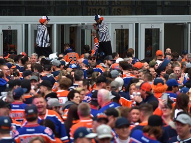 Fans enter Rogers Place from the tailgate party in the ICE district Plaza prior to the start of the Oilers game two against the LA Kings in Edmonton, May 4, 2022.