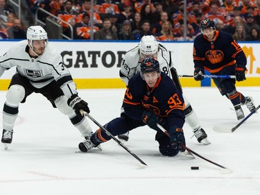 Edmonton Oilers' Ryan Nugent-Hopkins (93) battles L.A. Kings' Brendan Lemieux (48) and Matt Roy (3) during first period NHL action in Game 2 of their first round Stanley Cup playoff series in Edmonton, on Wednesday, May 4, 2022.