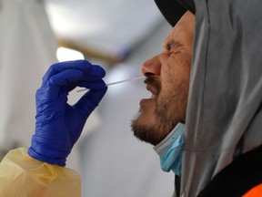 Provincial health workers perform coronavirus disease (COVID-19) nasal swab tests on Raymond Robins of the remote First Nation community of Gull Bay, Ontario, Canada April 27, 2020.