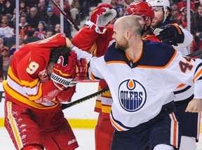 Zack Kassian (44) of the Edmonton Oilers pummels Matthew Tkachuk (19) of the Calgary Flames during an NHL game at Scotiabank Saddledome on Jan. 11, 2020 in Calgary.