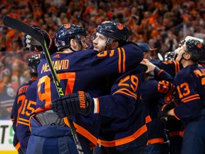 Connor McDavid (97) and Leon Draisaitl (29) of the Edmonton Oilers celebrate their victory against the Los Angeles Kings following Game 7 of the first round of the 2022 Stanley Cup playoffs at Rogers Place on May 14, 2022 in Edmonton.