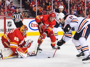 Zach Hyman #18 of the Edmonton Oilers takes a shot on Jacob Markstrom #25 of the Calgary Flames during the first period of Game Two of the Second Round of the 2022 Stanley Cup Playoffs at Scotiabank Saddledome on May 20, 2022.