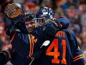 Connor McDavid (97) and goaltender Mike Smith (41) of the Edmonton Oilers celebrate their victory against the Calgary Flames in Game 4 of their Stanley Cup playoff series at Rogers Place on May 24, 2022, in Edmonton.