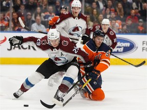 Edmonton Oilers' Connor McDavid (97) battles Colorado Avalanche's Nathan MacKinnon (29) during the first period of a NHL hockey game at Rogers Place in Edmonton, on Thursday, Nov. 14, 2019.