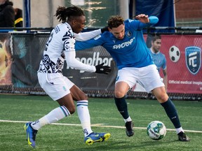 FC Edmonton’s Mastanabal Kacher (7) battles Pacific FC’s Georges Mukumbilwa (2) during second half Canadian Premier League action at Clarke Stadium in Edmonton, on April 27, 2022.