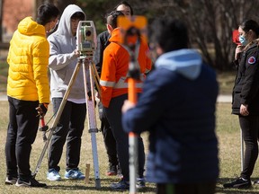 Civil engineering students take a surveying course in the quadrangle at the University of Alberta in Edmonton on Friday, April 29, 2022. Photo by David Bloom