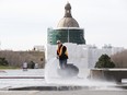 The dome of the Alberta Legislature is visible in the background as crews clean Violet King Henry Plaza in Edmonton, Tuesday May 4, 2022.