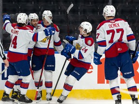 Edmonton Oil Kings' Dylan Guenther (11) celebrates a goal with teammates on Red Deer Rebels' goaltender Chase Coward during the first period of Game 1 of their Round 2 WHL Playoffs series at Rogers Place in Edmonton, on Thursday, May 5, 2022.
