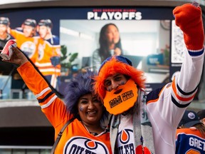 Oilers fans Jesse and Neil Pandya cheer during the Ford Tailgate Party outside of Rogers Place before watching Game 7 of the NHL Stanley Cup playoffs series between the Edmonton Oilers and the L.A. Kings in Edmonton, on Saturday, Nov. 14, 2022.