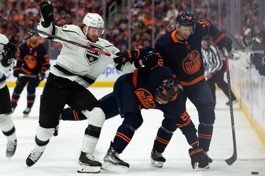 Edmonton Oilers' Evander Kane (91) and Zach Hyman (18) battle L.A. Kings' Olli Maatta (6) during first period NHL Stanley Cup playoffs action at Rogers Place in Edmonton, on Saturday, May 14, 2022.