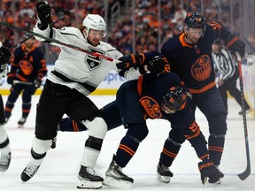 Edmonton Oilers' Evander Kane (91) and Zach Hyman (18) battle L.A. Kings' Olli Maatta (6) during first period NHL Stanley Cup playoffs action at Rogers Place in Edmonton, on Saturday, May 14, 2022.